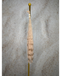 Four bundles of golden blond body wavy bulk hair arranged together.